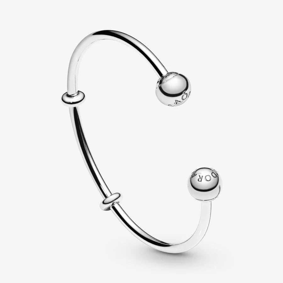 Silver open bangle with silicone stoppers and interchangeable end caps