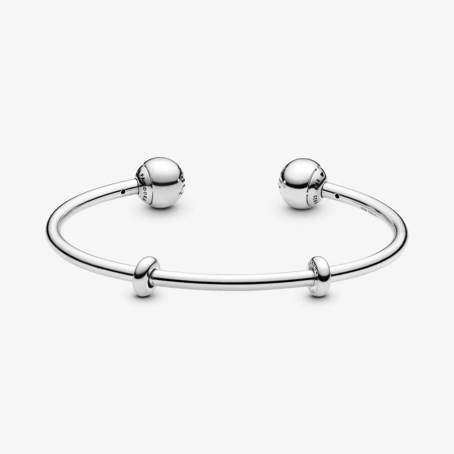 Silver open bangle with silicone stoppers and interchangeable end caps