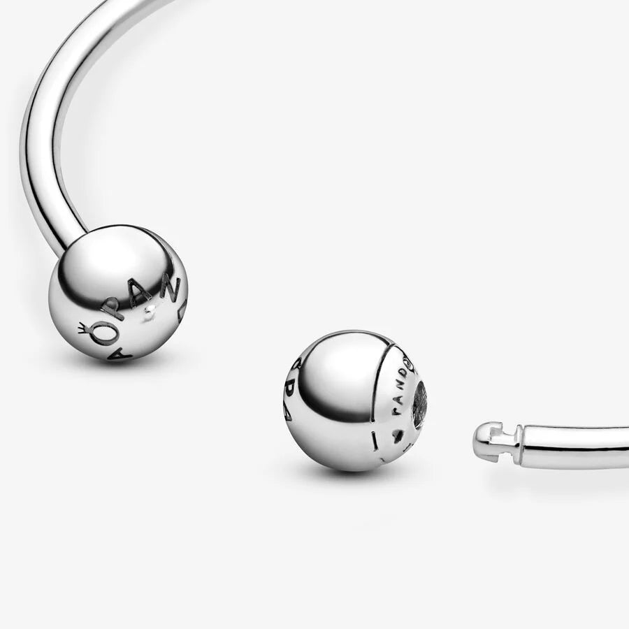 Silver open bangle with silicone stoppers and interchangeable end caps